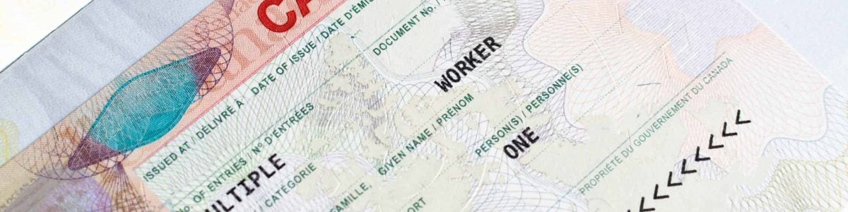 Canadian working visa in passport closeup. Immigration to Canada concept.