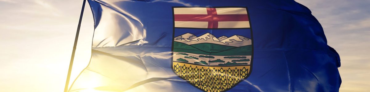Alberta province of Canada flag textile cloth fabric waving on the top sunrise mist fog