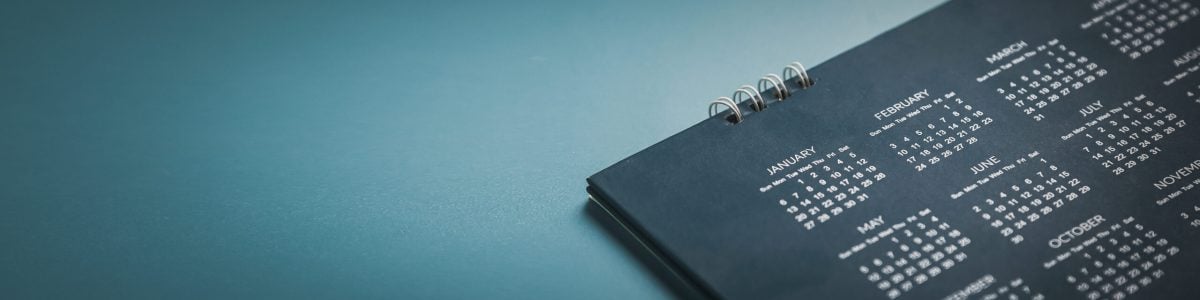 Embroidered red pins on a calendar event Planner calendar,clock to set timetable organize schedule,planning for business meeting or travel planning concept.