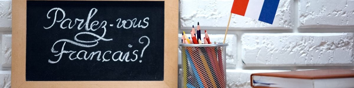 Do you speak French written on board, France flag standing in box, language