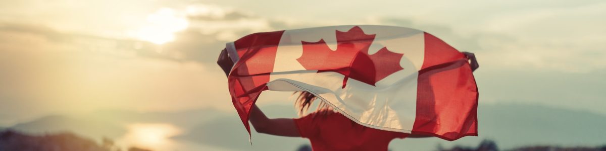 Happy child teenage girl waving the flag of Canada while running at sunset