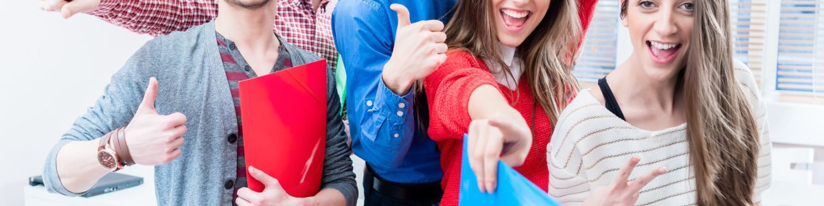Group of students celebrating success in exams being cheerful throwing arms up